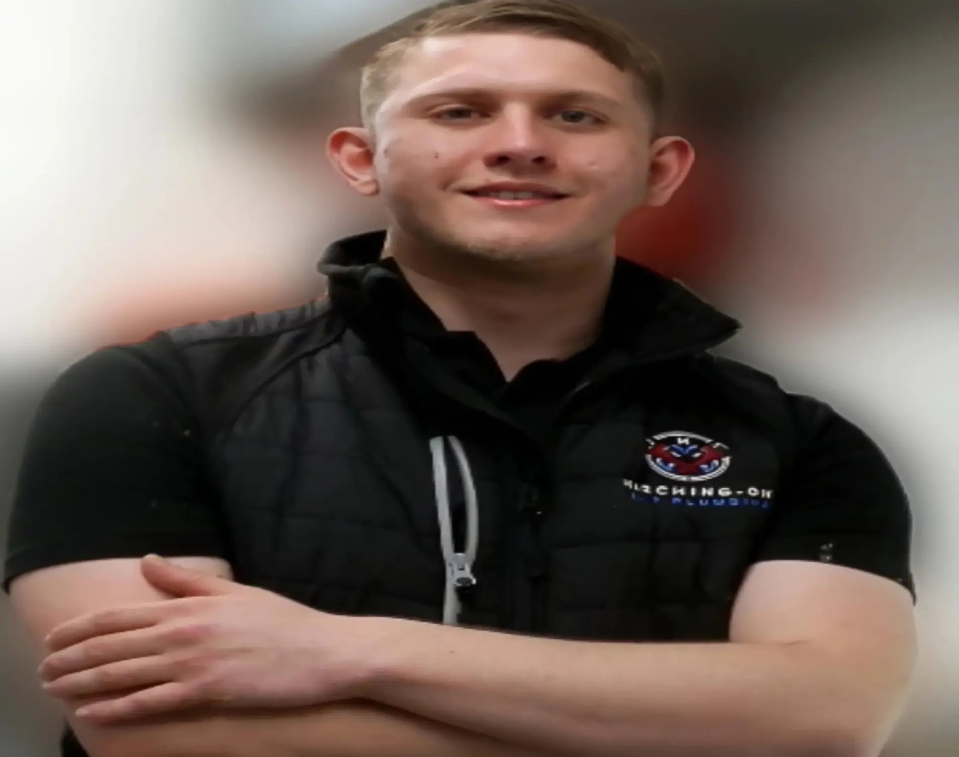 Louis Marchant wearing Marching-On 24/7 Plumbing uniform with arms crossed